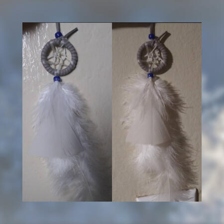 Dreamcatcher. Grey leather, white feathers, blue beads.
